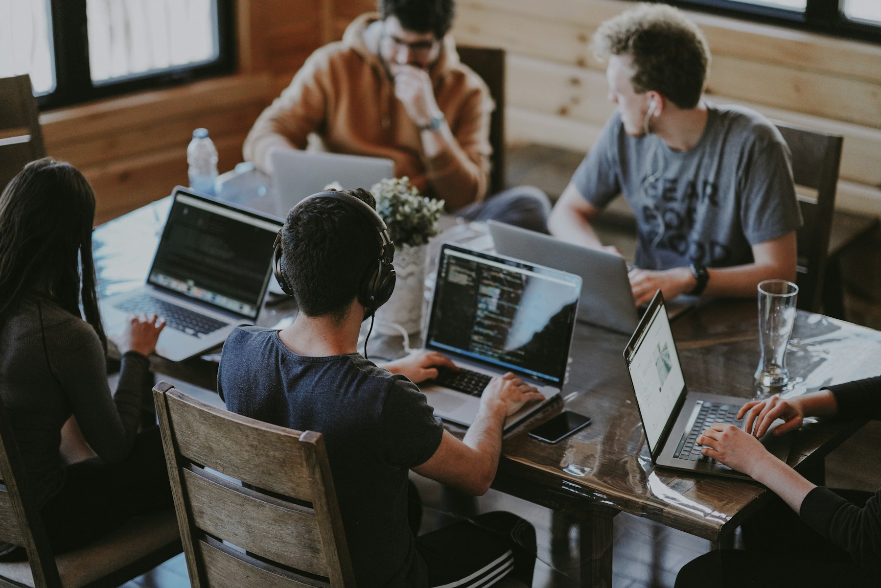 A startup team working together around laptops